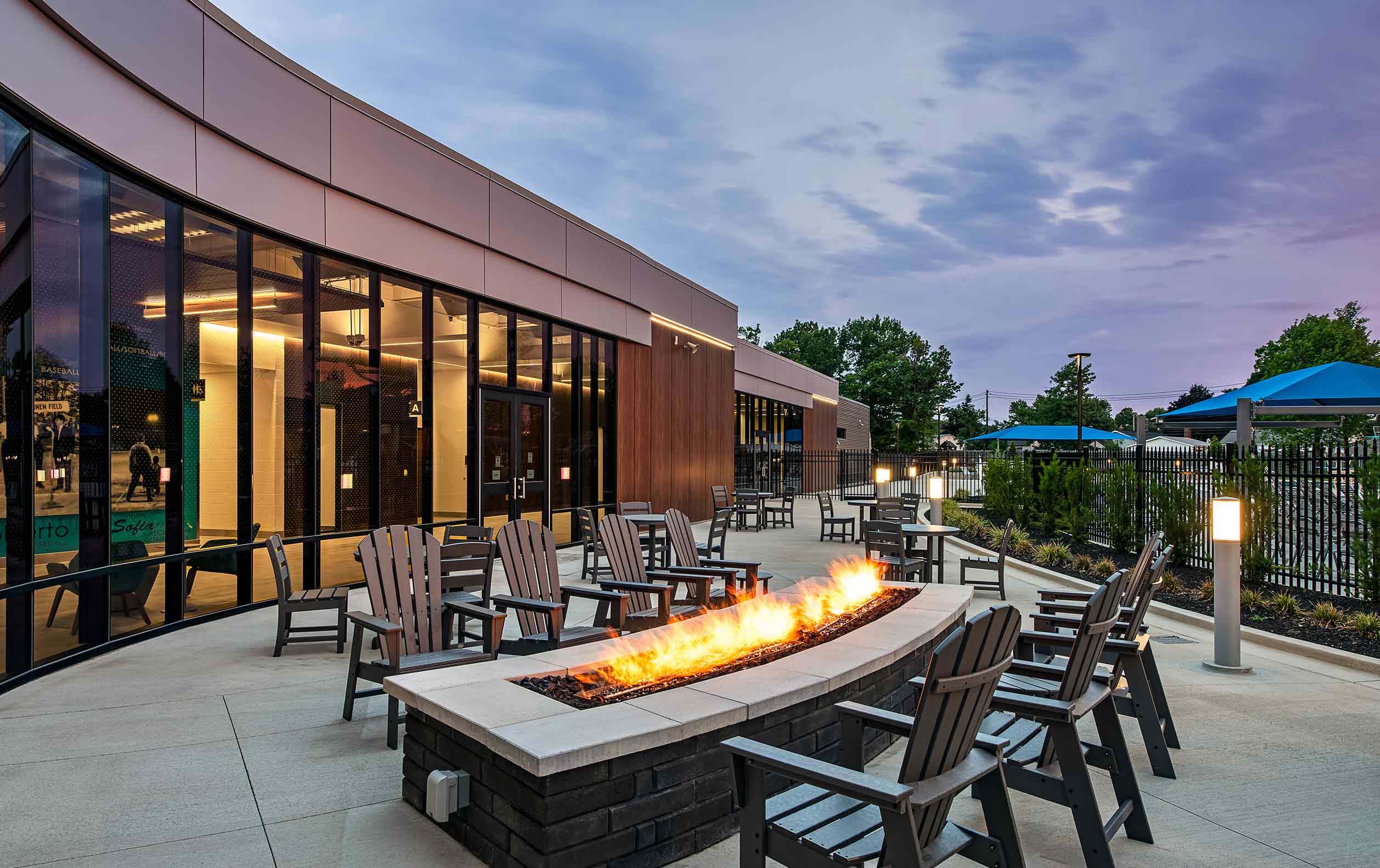 Aquatic center patio with outdoor fireplace next to pool