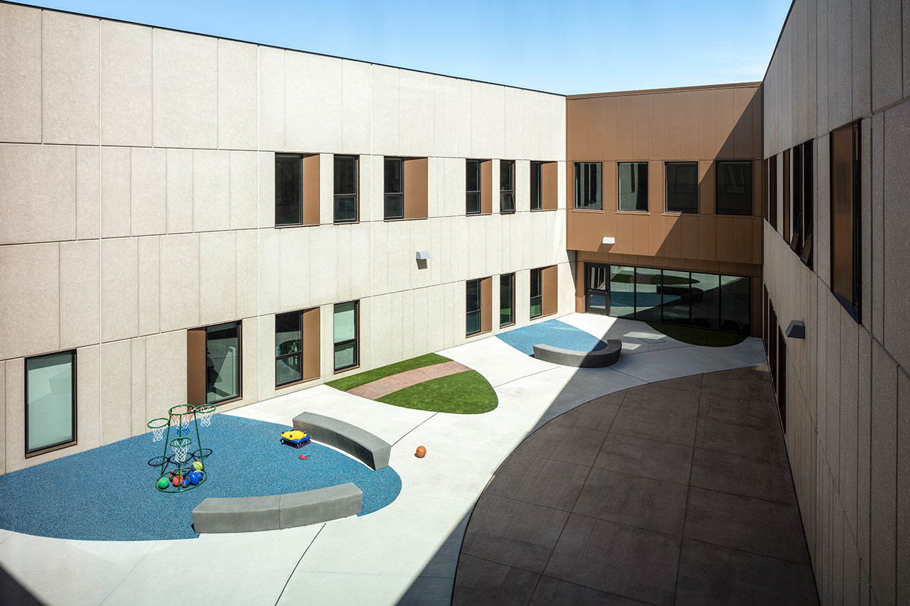 Courtyard with different flooring surrounded by classrooms