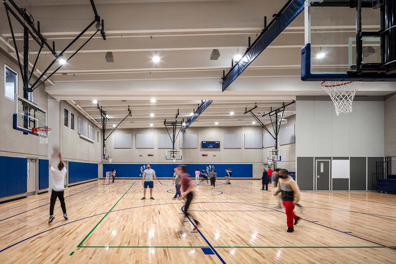 Students playing basketball in gymnasium