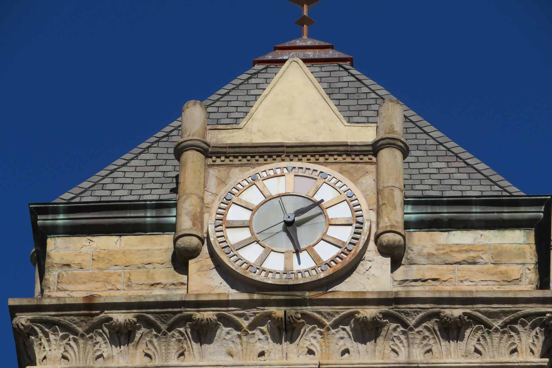 Exposure to the elements had faded the city hall clock and worn the masonry around it
