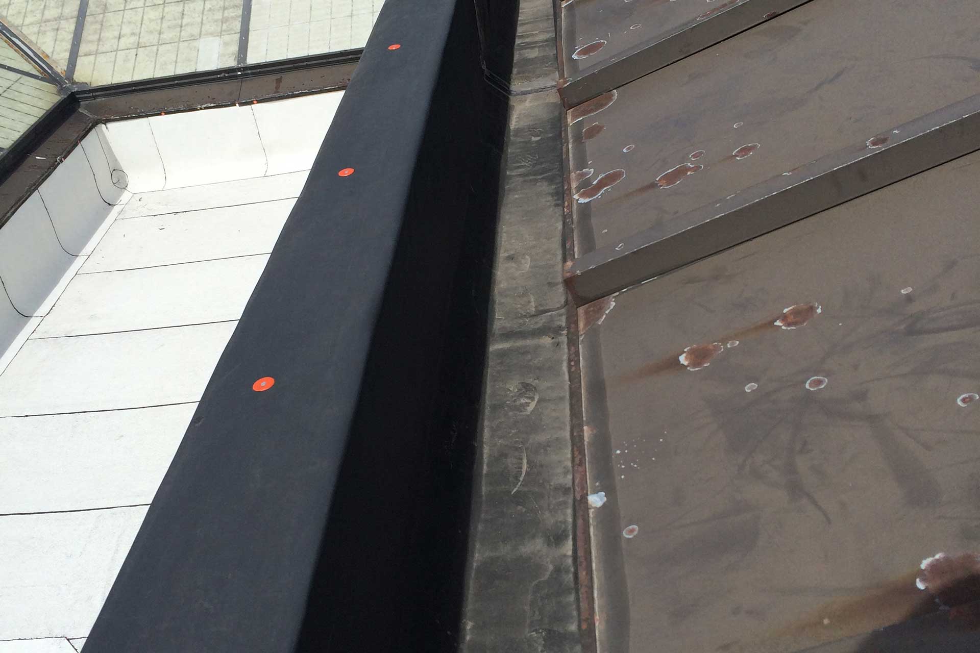 Metal standing seam roof repairs including rebuilt concealed gutter system