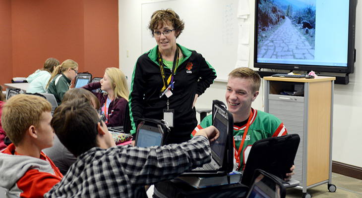 Teacher helping students in experimental classroom