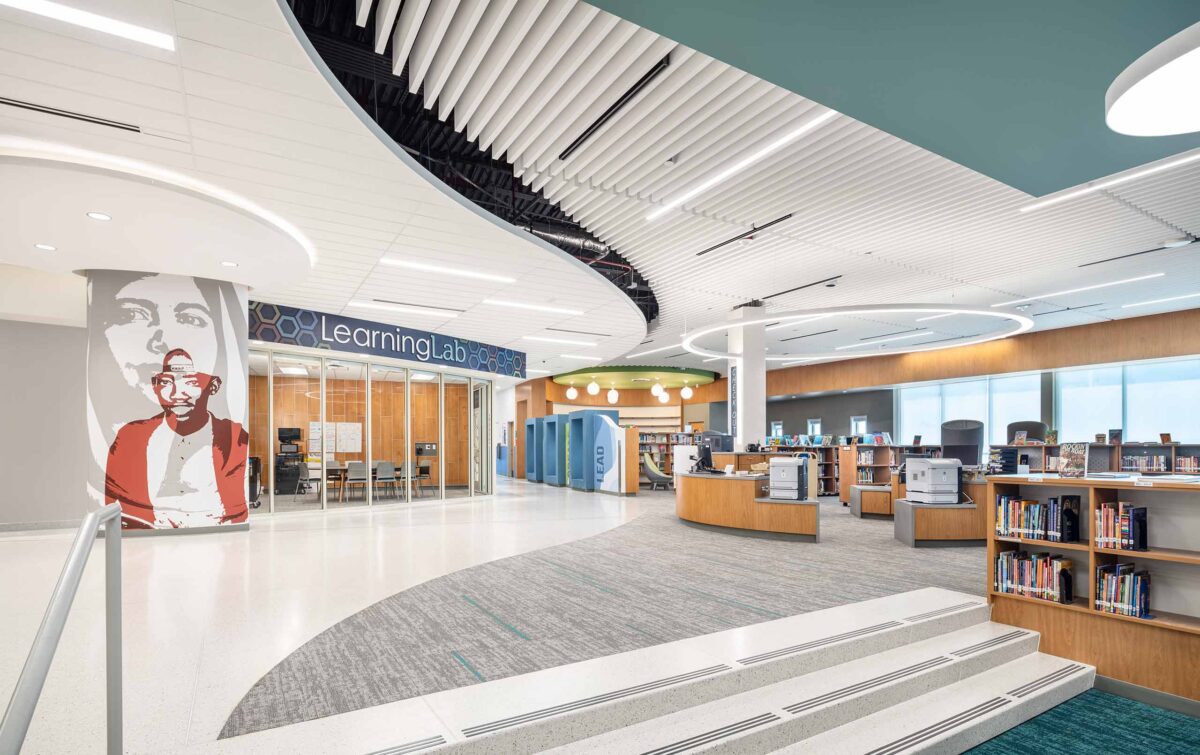 Contemporary middle school library media center with natural light, openness, and flexible furniture