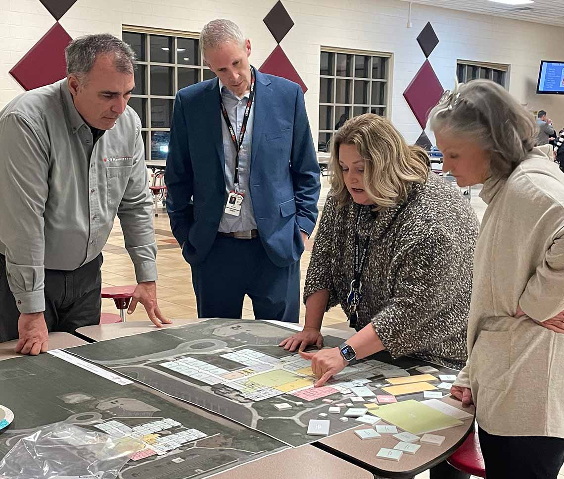 School district representatives discussing a floor plan