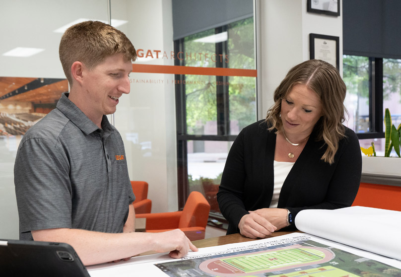 Two people collaborating in the Legat office