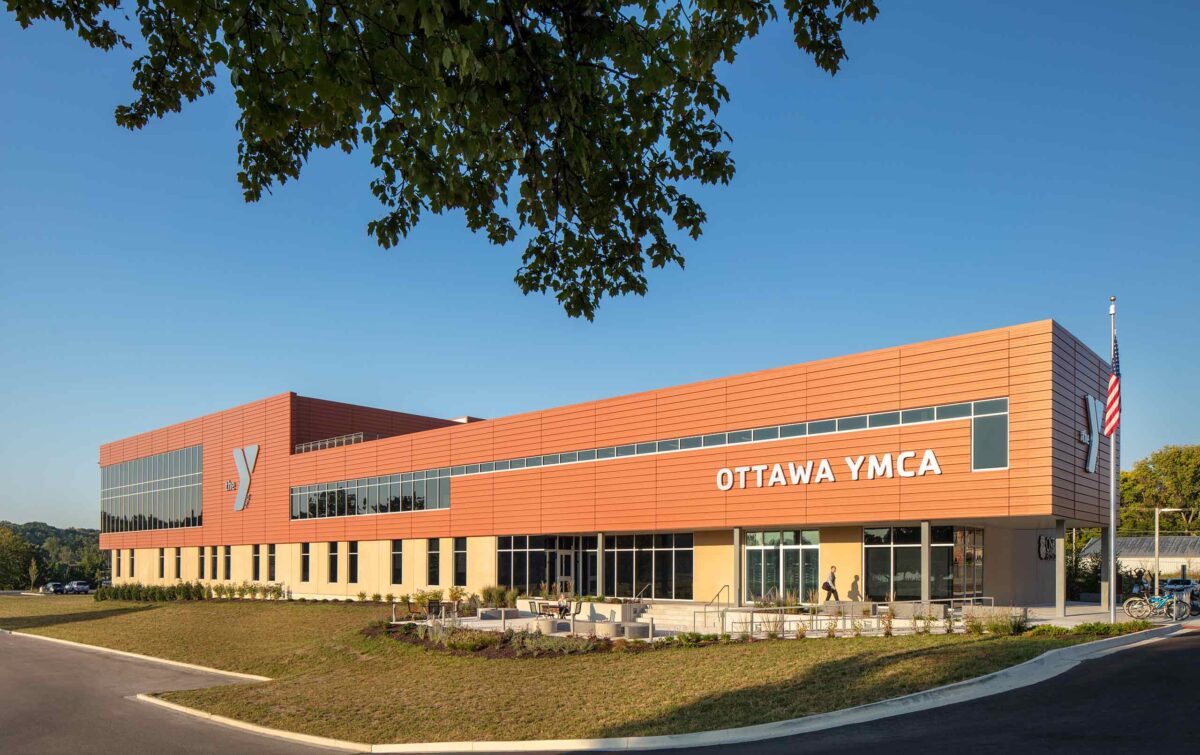 Daytime view of Ottawa YMCA exterior featuring metal panels and windows, plaza