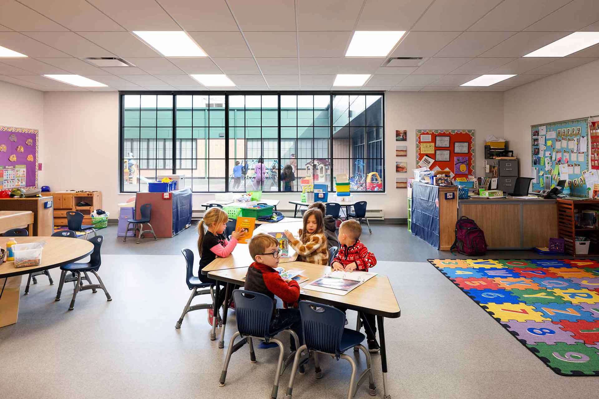 Preschool students in classroom with large window 