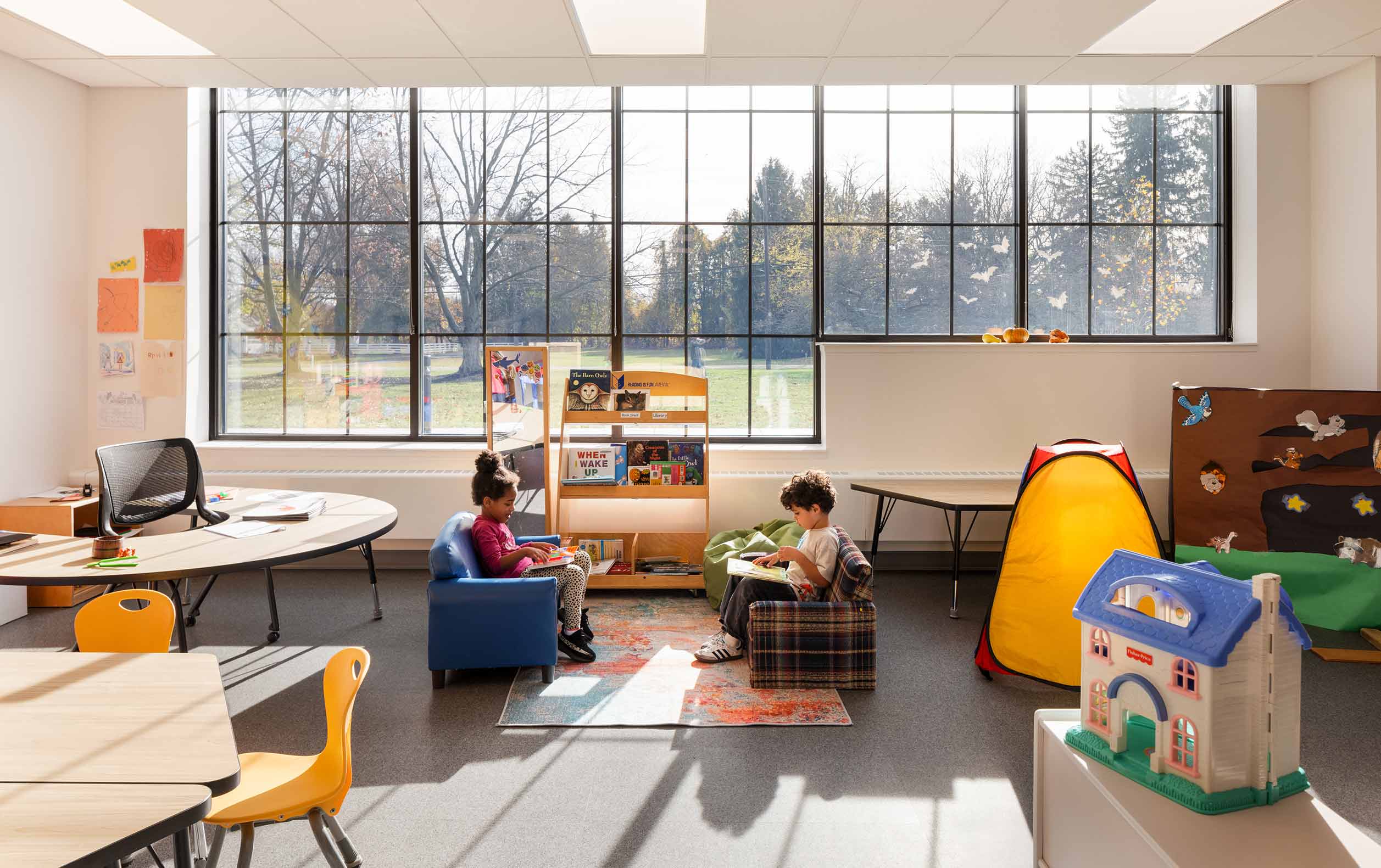 Preschool classroom with large windows displaying trees