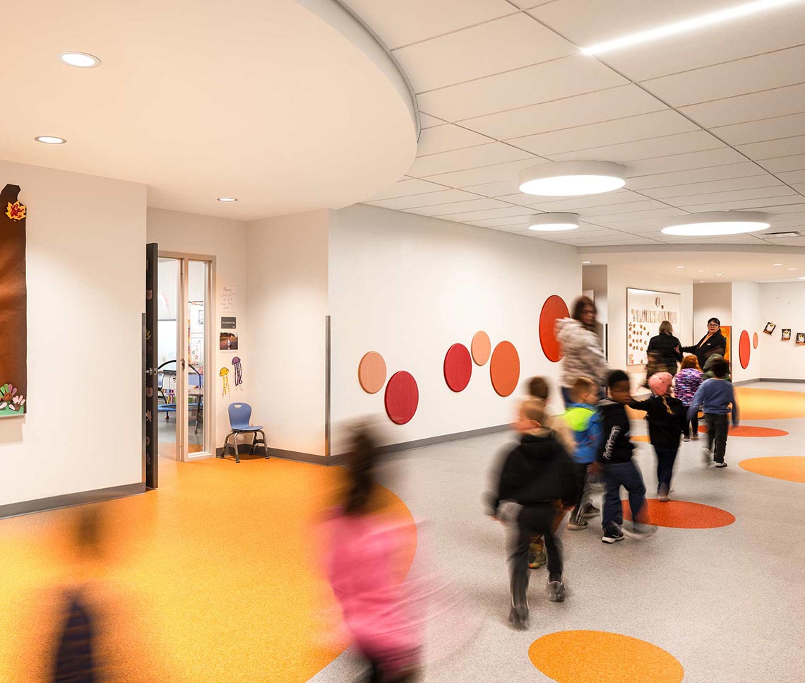 Preschool corridor with students and decorative spheres