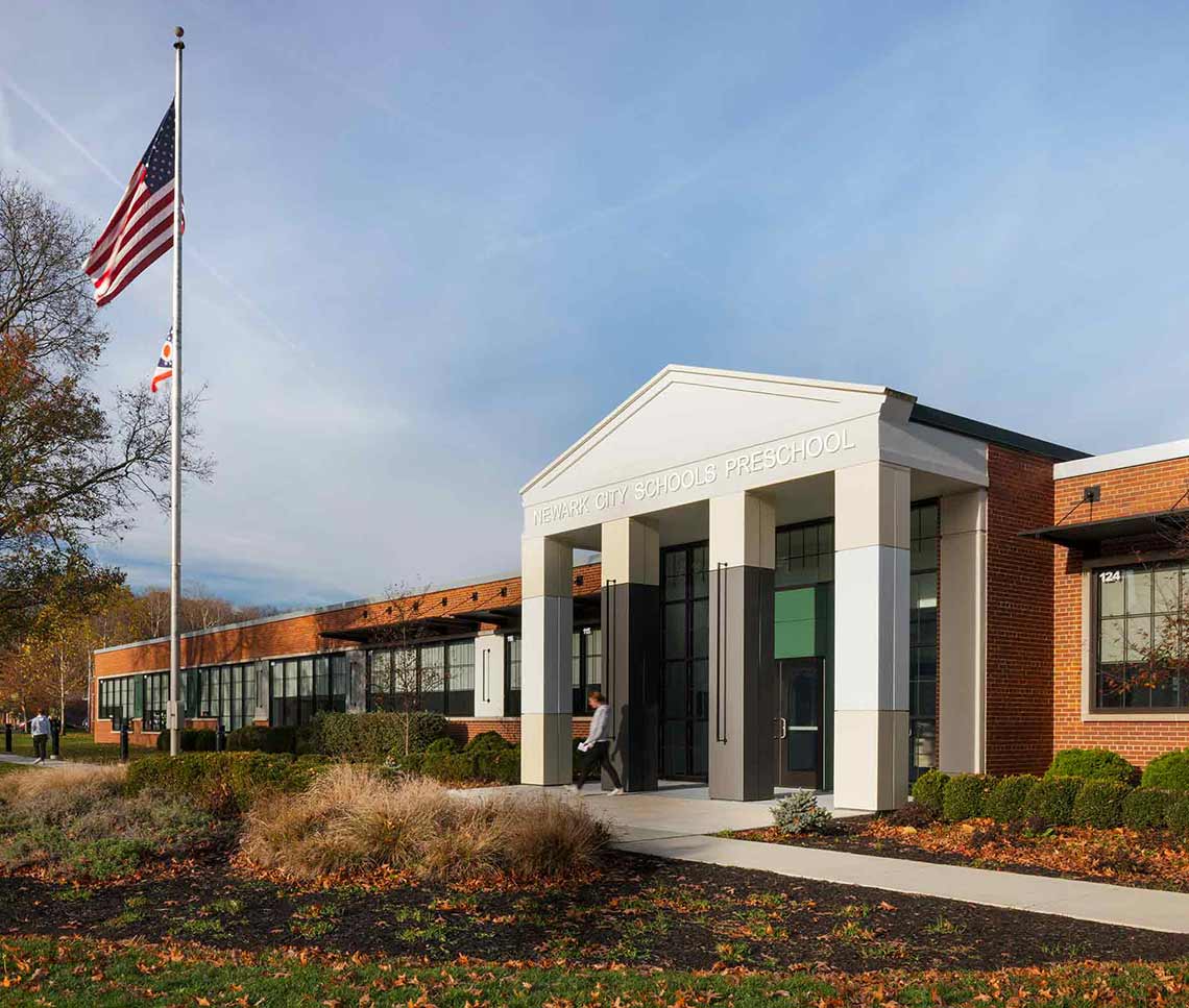 Exterior of preschool with flag and columns