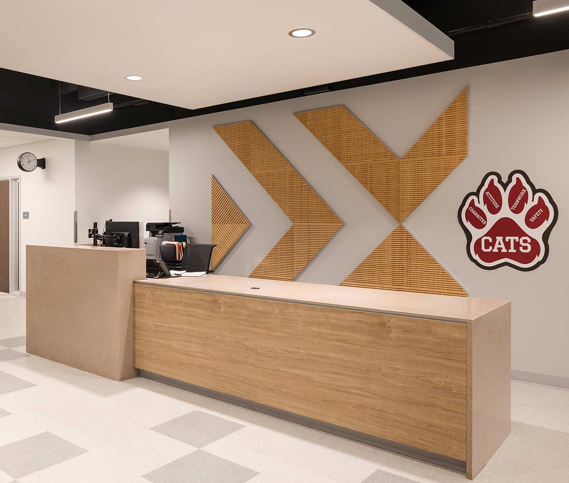 High school lobby with desk and school logo